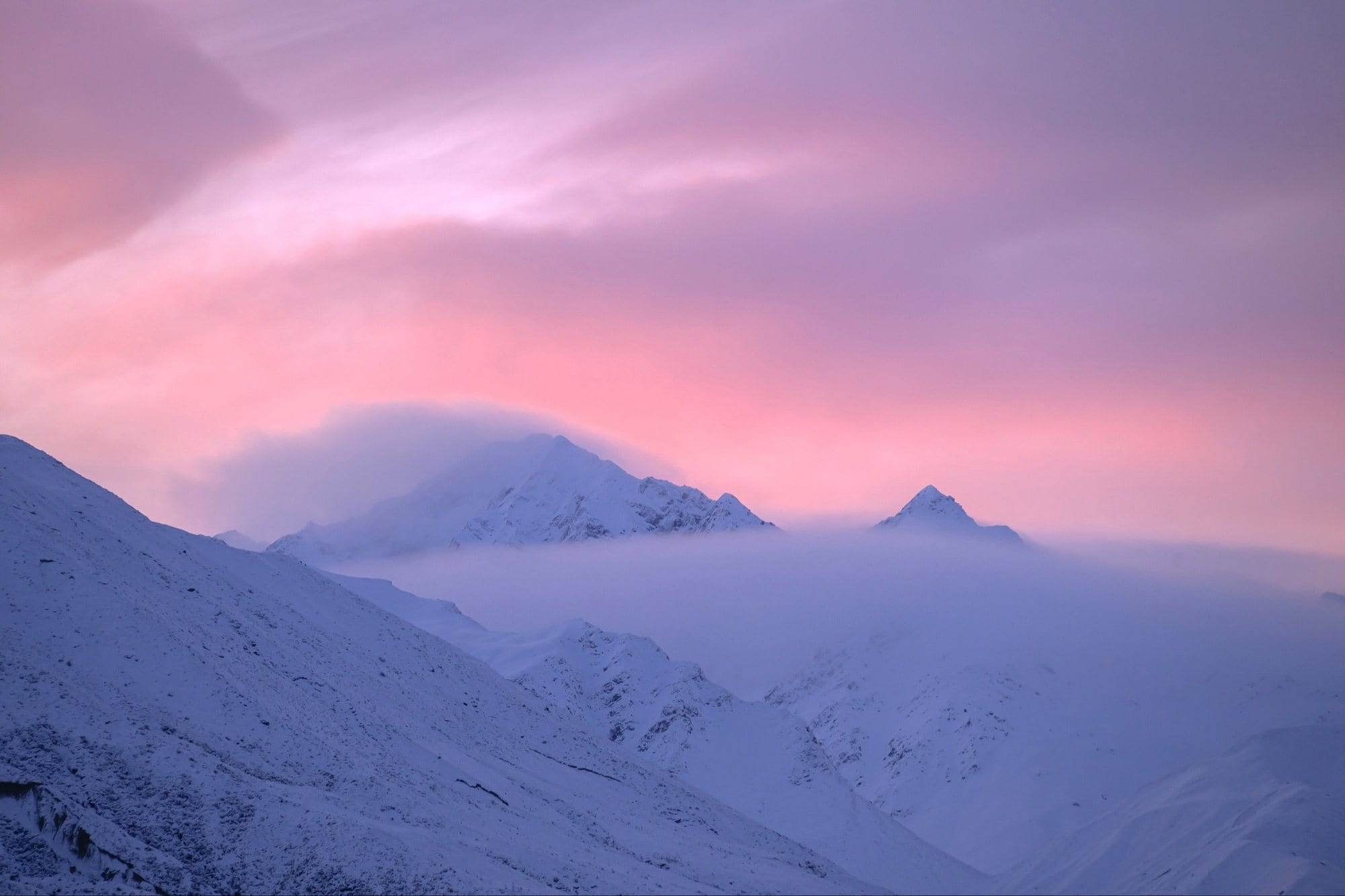 Snowy mountains at pink dusk